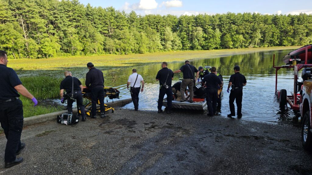 Emergency personnel work to revive the victim on the rescue boat as they prepare to transfer him to the hospital.