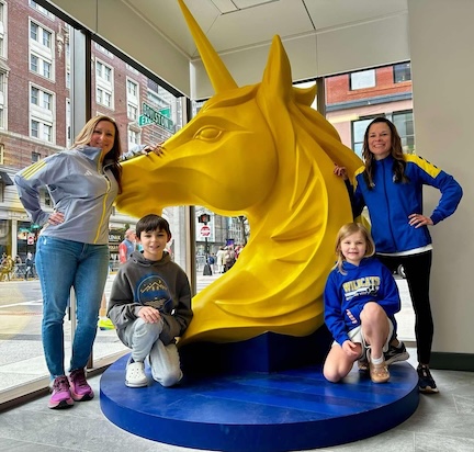 2 runners, 2 kids and the unicorn logo of the BAA