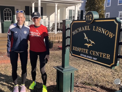 2 runners with Respite Center sign