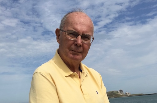 Man with ocean view behind him