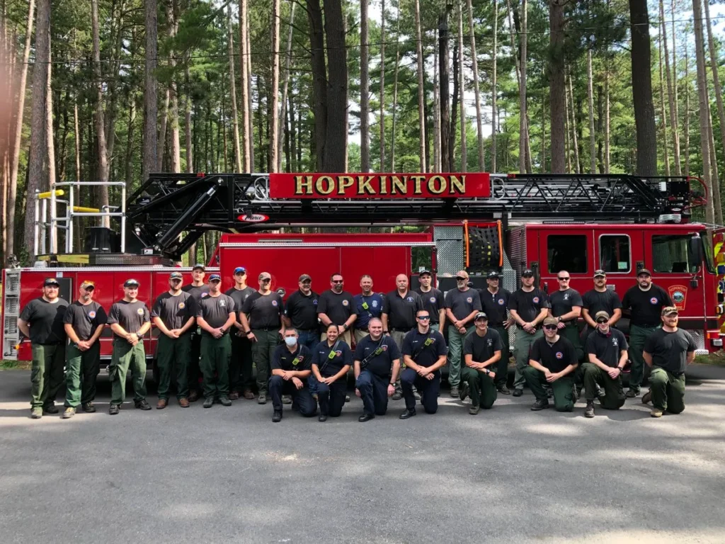 Firefighters in front of a ladder truck