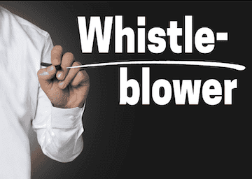 Man writing Whistleblower on clear board