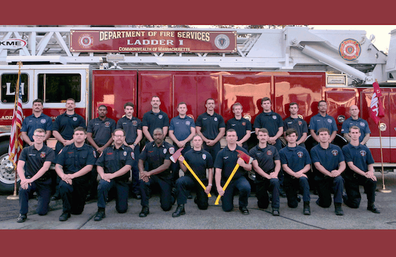 Firefighters in front of a fire truck