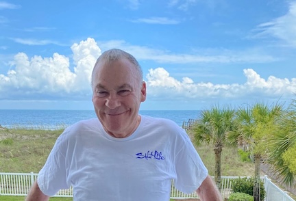 Smiling man with ocean behind him