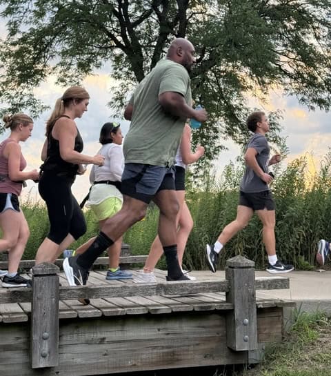 People running over a wooden bridge