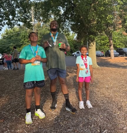 Man standing with a boy and girl