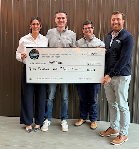 Four people holding a giant check for Live 4 Evan.