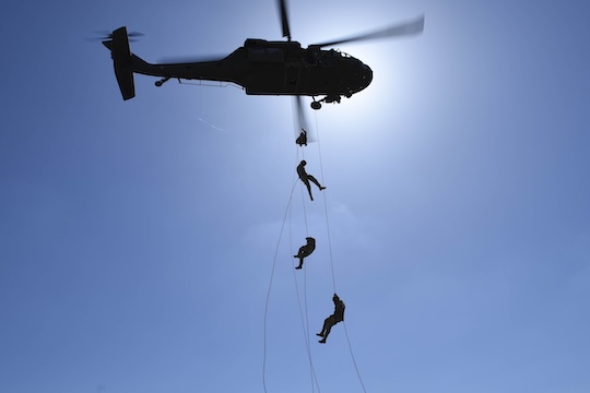 Airmen rappel from an Army Black hawk helicopter